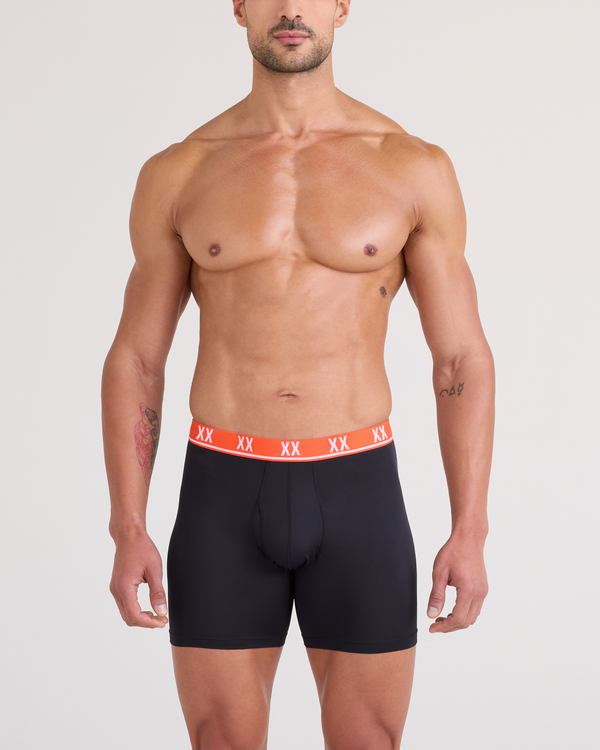 Front - Model wearing Essential Performance Mesh Boxer Brief in Black-Vermillion WB