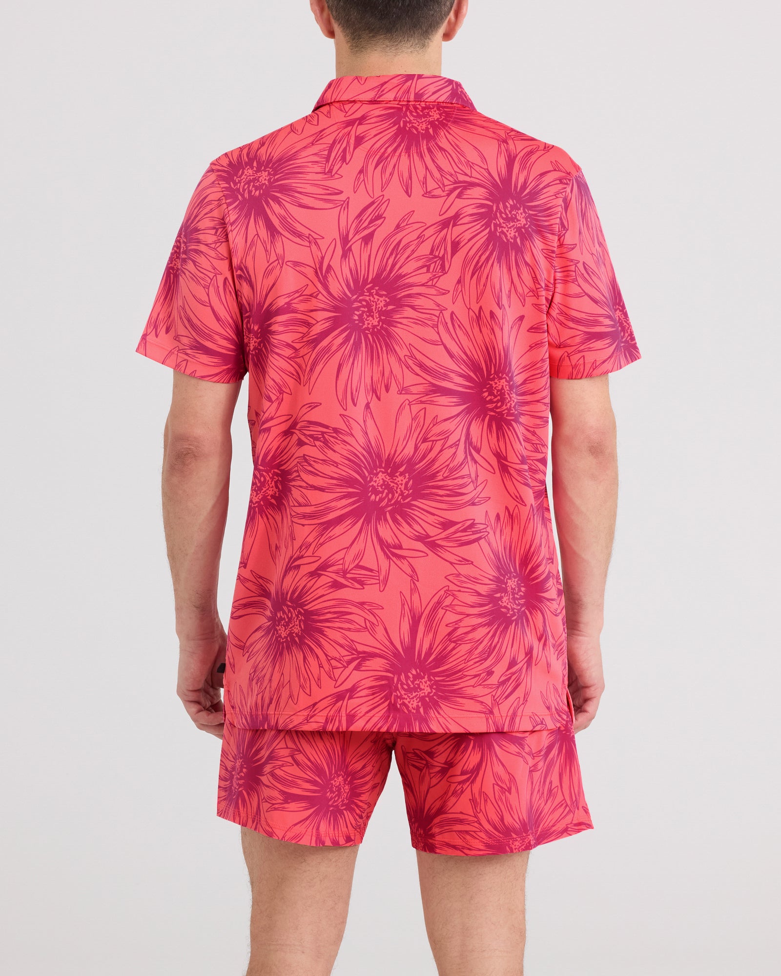 Back - Model wearing Droptemp Dry Resort Polo in Big Daisy-Gumball
