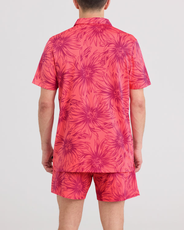Back - Model wearing Droptemp Dry Resort Polo in Big Daisy-Gumball