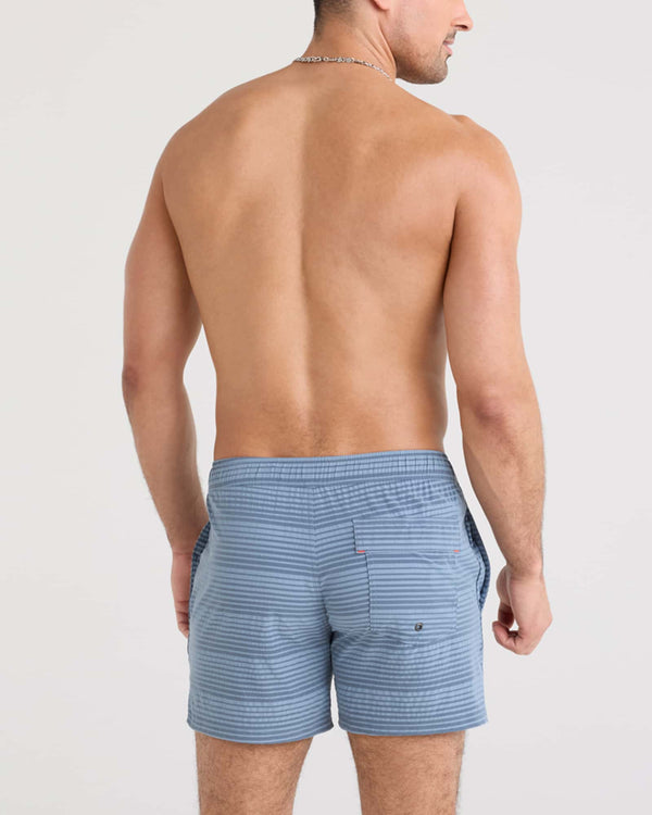 Back - Model wearing Oh Buoy 2N1 Swim Volley 5" in India Ink/Blue Stripe