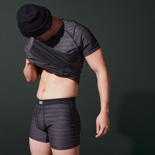 Model posing in DropTemp Cooling Mesh Boxer Brief Fly in Black Heather