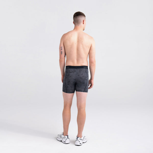 Back - Model wearing Kinetic Light-Compression Mesh Boxer Brief in Optic Camo- Black