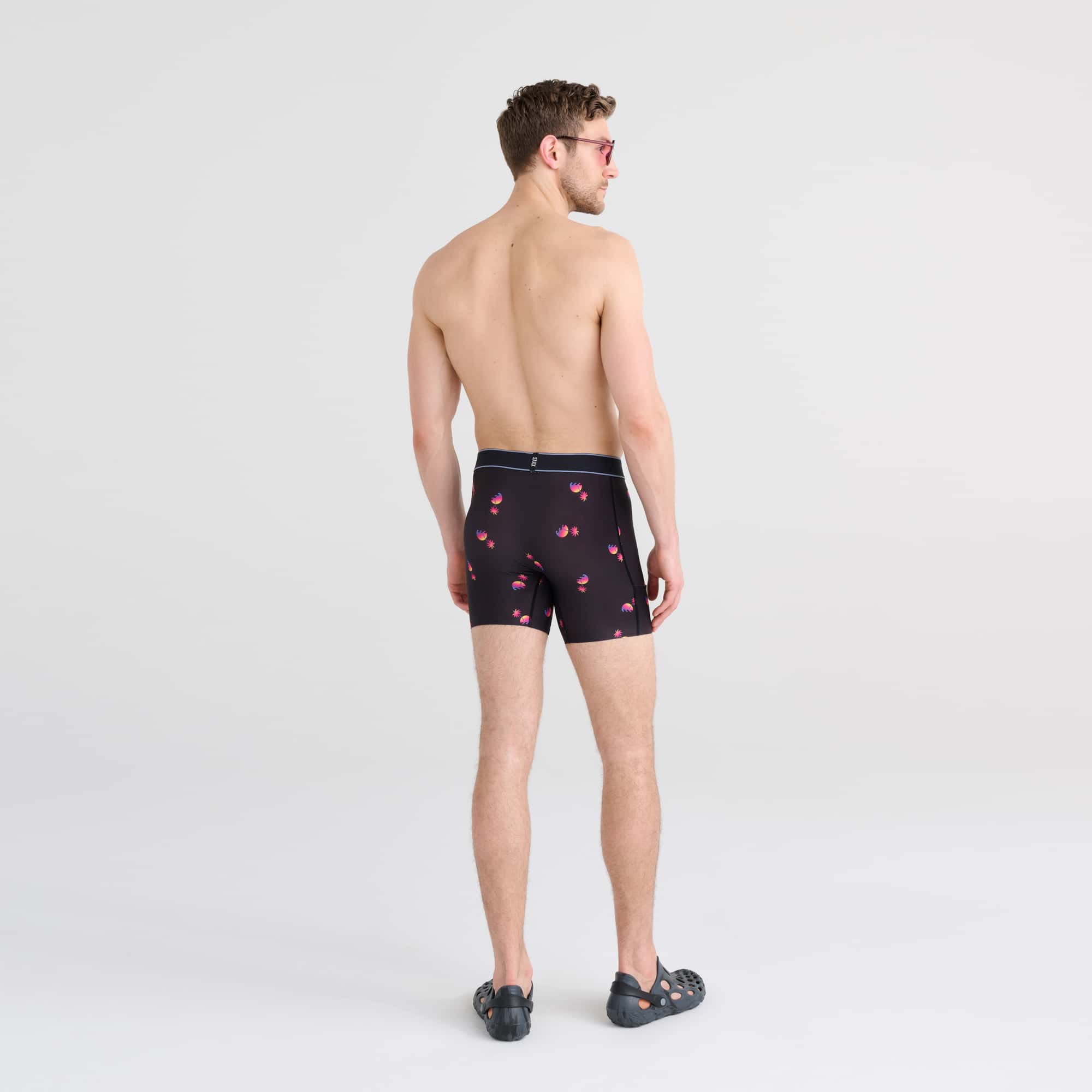 Back - Model wearing DropTemp Cooling Hydro Boxer Brief in Sunset Waves- Black