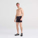 Front - Model wearing DropTemp Cooling Hydro Boxer Brief in Sunset Waves- Black