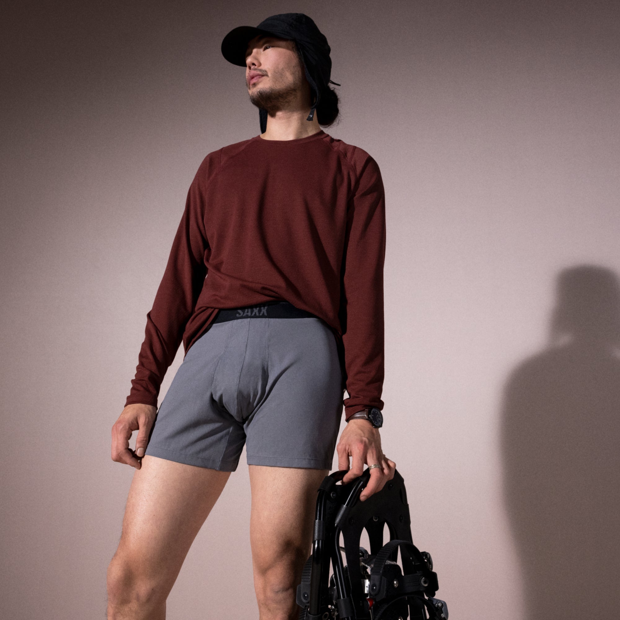 Model posing in Roast Master Mid-Weight Baselayer Long Sleeve Crew in Dark Brick