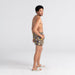 Back - Model wearing Oh Buoy 2N1 Swim Trunk 5" in Summer Stencil- Camo