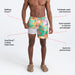Model wearing Oh Buoy 2N1 Swim Volley Short 7" in Island Patchwork- Multi with liner