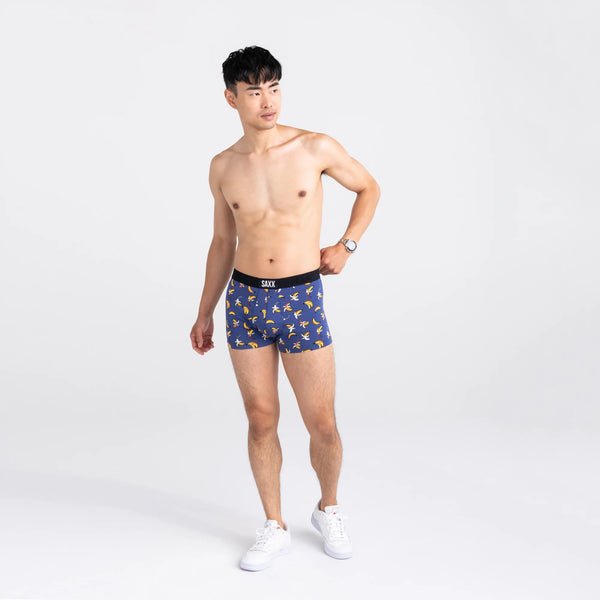 Front - Model wearing Vibe Super Soft Trunk in Rainbow Bananas- Navy